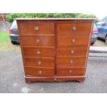 A compactum, formed as a chest of drawers, having cupboard door opening to reveal hanging space to