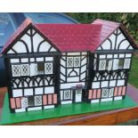 A painted dolls house, 36ins x 15ins, height 23ins