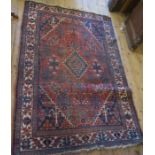 An Eastern design rug, the red field decorated with flowers, 79ins x 53ins