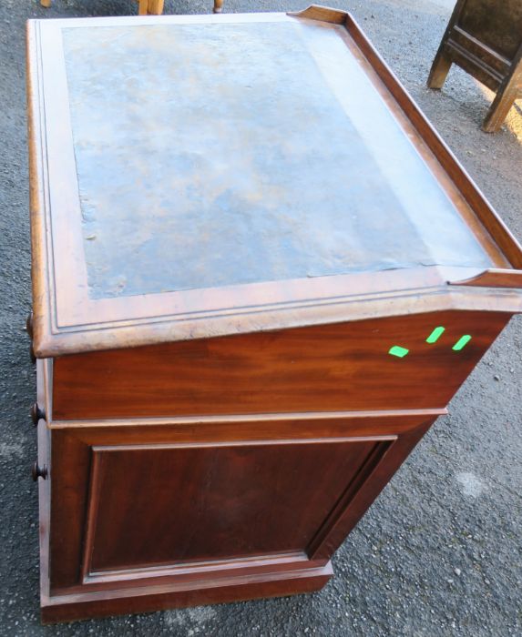 A 19th century mahogany desk, with sloping writing surface, over six drawers, raised on a plinth - Image 4 of 4