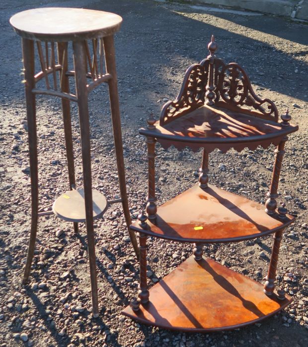 A set of walnut tiered corner shelves, with pierced top and turned columns, height 34ins, together