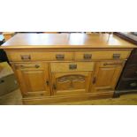 A 19th century Arts and Crafts style pale oak buffet, or sideboard, fitted with two frieze