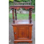 A 19th century mahogany cupboard whatnot, having a spindle turned gallery with shelf, over a