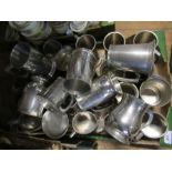A quantity of pewter mugs