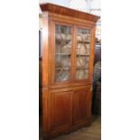 A 19th century mahogany floor standing corner cabinet, the upper section having a pair of glazed