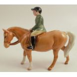 A Beswick model, of a boy in green jacket riding a palomino pony, height 5.75ins