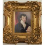 A 19th century portrait miniature, painted on ivory of a man holding a rolled piece of music, 3.5ins