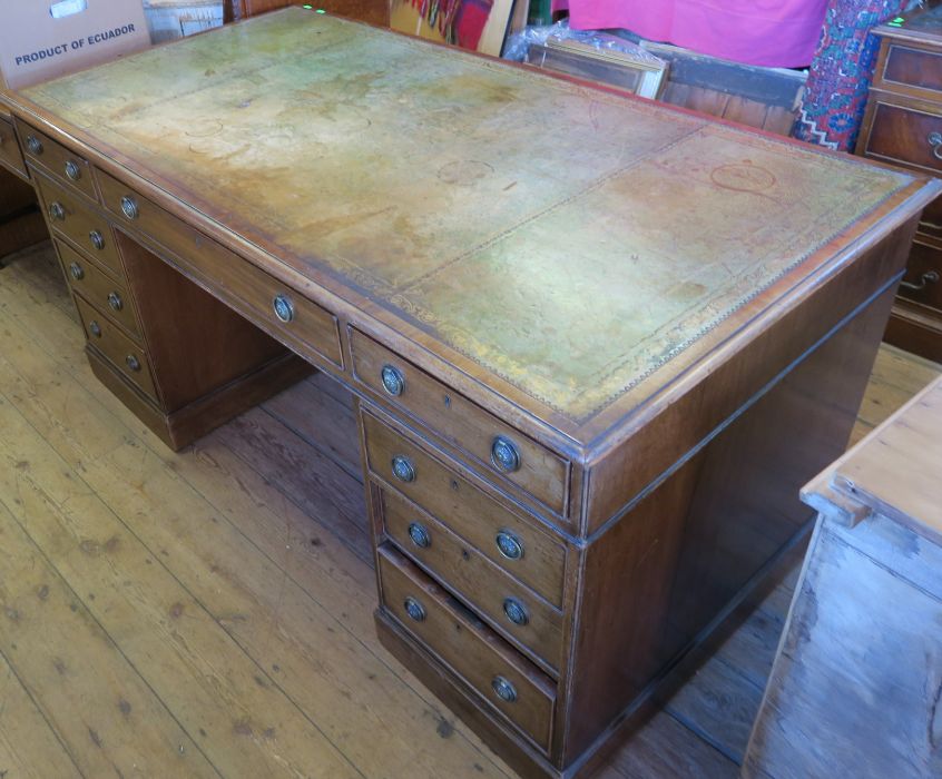 A reproduction mahogany partners desk, fitted with one long frieze drawer flanked by two further