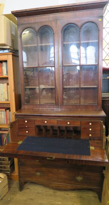 A 19th century mahogany cabinet, the glazed upper section having a pair of doors and adjustable