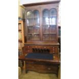 A 19th century mahogany cabinet, the glazed upper section having a pair of doors and adjustable