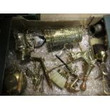 A box of assorted brass ware, to include jug, models, bell etc