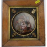 A 19th century reverse painting on convex glass, of three people in landscape, diameter 5ins, in a