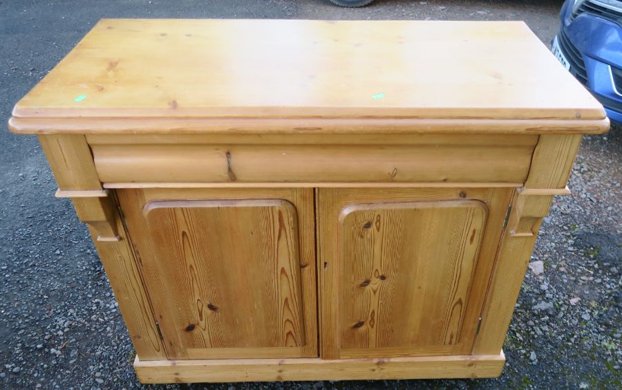 A 19th century pine chiffonier, fitted with one longer frieze drawer, over two panel doors, width