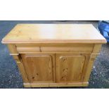 A 19th century pine chiffonier, fitted with one longer frieze drawer, over two panel doors, width