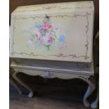 A painted bureau, decorated with flowers, width 24ins, together with a white dressing table