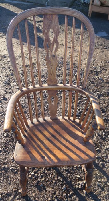 An Antique elm Windsor armchair, with pierced splat and H stretcher