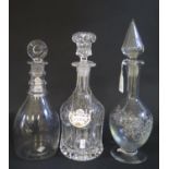 A 19th Century Glass Decanter with lozenge shaped stopper (28cm) and two others