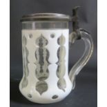 A 19th Century Bohemian Opaque and Slice Cut Glass Tankard with Porcelain Cover painted with a