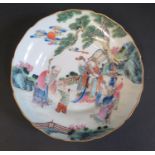 A 19th Century Chinese Famille Rose Saucer decorated with figures in a landscape, six character mark