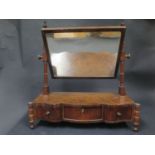 A 19th Century Mahogany Shape Front Swivel Toilet Mirror with three frieze drawers, 59.5cm wide