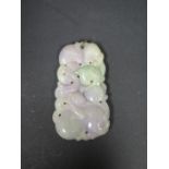 A Chinese Carved Lavender Jade Pendant decorated with an animal and folliage, 65mm