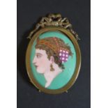 A 19th Century Porcelain Plaque decorated with a lady's bust in profile and in a brass easel back