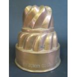 A 19th Century Spiral Copper Jelly Mould by Trottier, stamped St. John's Coll. Cambridge, 14cm high