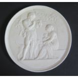 A 19th Century Parian Ware Plaque decorated with classical figures, 14.5cm diam.