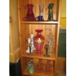 A Victorian Cranberry Glass Vase and collection of glass and ceramic candlesticks