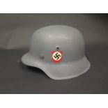 A WWII German Helmet, repainted with SS decals, stamped 3453