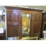 A 1930's Triple Wardrobe with central mirrored door, 189(w)x207(h)x58(d)cm