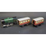 A Hornby Clockwork Tinplate Train Set in working order. Train missing chimney and carriages sun-