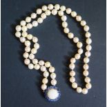 A Single Strand Pearl Necklace with a large white opal and blue stone pendant, the 15.5mm singlet