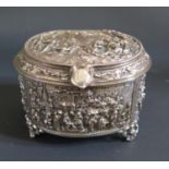 A French Silvered Copper Hinged Oval Casket decorated in relief with drinking and hunting scenes,