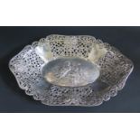 A German .800 Silver Bread Basket with repoussé decoration of a recumbent lady playing harp and