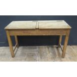 A Twin School Desk, the brass inkwell slides stamped Andrew Bentley Ltd., 101cm diam.