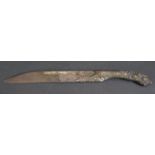 An 18th Century Middle Eastern Knife, the steel blade with silver inlay and carved wooden handle,
