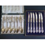An Cased Set Six Continental Gilt Teaspoons stamped 000 and six cased sterling silver handled tea