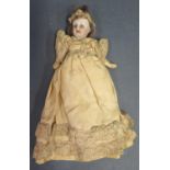 A German Porcelain Headed Doll with composite arms and legs