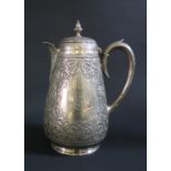 A Victorian Silver Coffee Pot in the Indian Style with heavily decorated acanthus leaf decoration,