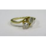 A Diamond Two Stone Crossover Ring dated 19/11/13, hallmarks rubbed but appears to be 18ct, size