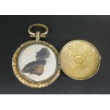 'IN MEMORY OF' _ A Gilt Memorial Locket with a sepia pen and ink silhouette bust of a gentleman,