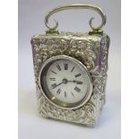 A Small Victorian Silver Carriage Clock decorated with scrolling foliate work, French movement with
