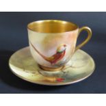 A Royal Worcester Coffee Cup and Saucer painted with a Golden Pheasant, saucer signed R. Austin.