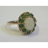 A 9ct Yellow Gold, White Opal and Peridot Ring, size K.5, 2.3g