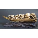 An Antique Japanese Carved Ivory Katabori Netsuke in the form of a fishing boat with five