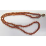A Georgian Coral Bead Necklace with carved heart pendant, 75cm, 50g, beads c. 6.5mm