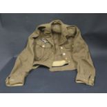 A WWII German Army Jacket, stamped with Eagle and Swastika stamp and with Royal Navy buttons
