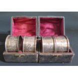 Two George V Cased Pairs of Silver Napkin Rings with chased acanthus leaf decoration, Birmingham