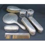 A Birmingham Silver Seven Part Dressing Table Set, year matched and one other brush